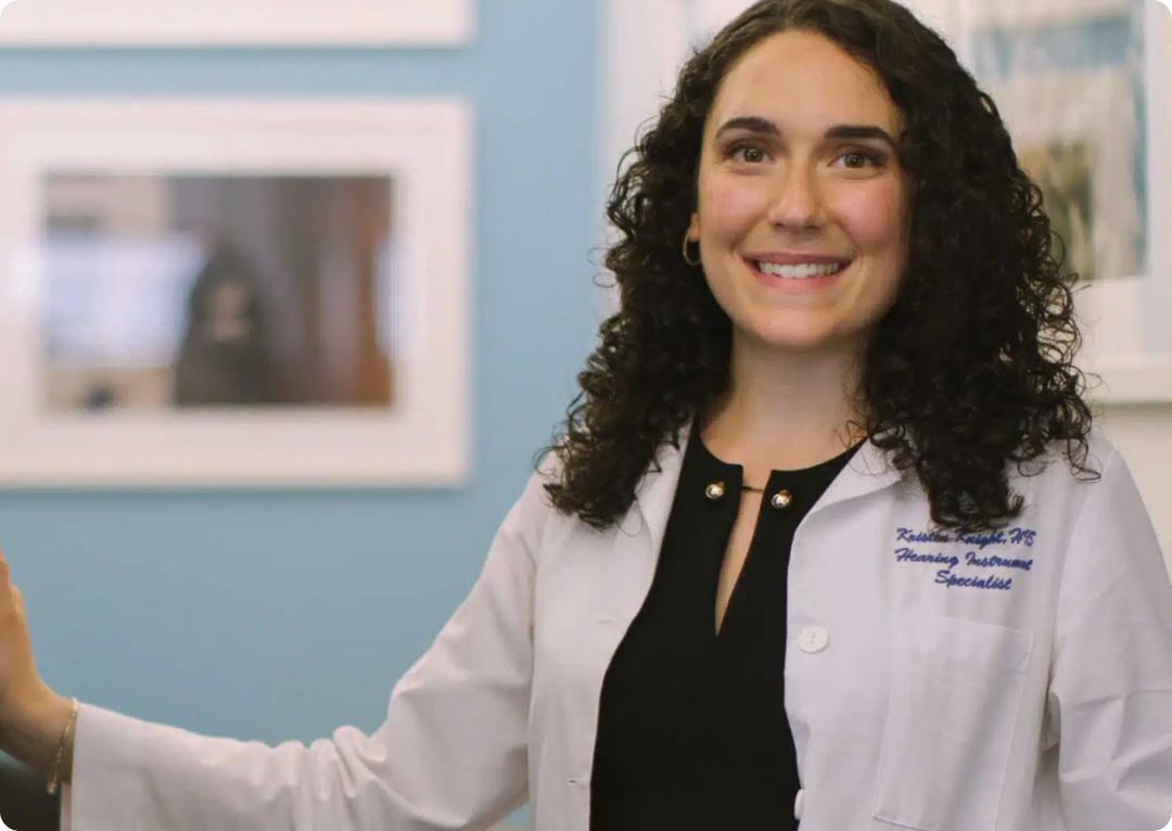 doctor posing in front of blue wall