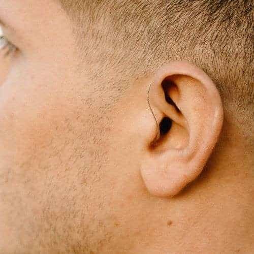 Man wearing behind the ear hearing aid